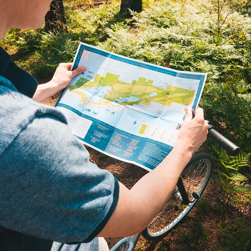 A person studying a map to explore a beach resort in the Gulf Coast region